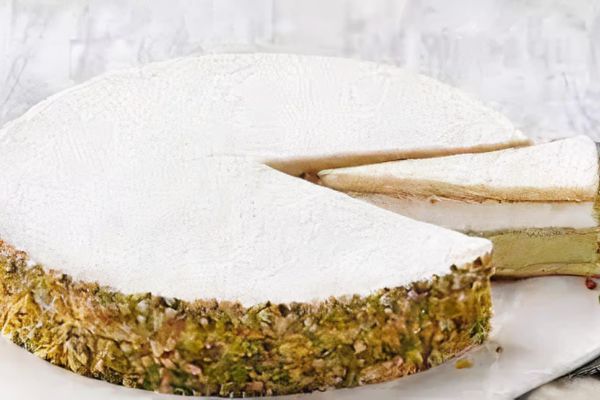 Rich pistachio ricotta cake with a crunchy pistachio crust and creamy filling, dusted with powdered sugar.
